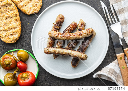 Grilled white sausages. 67195154