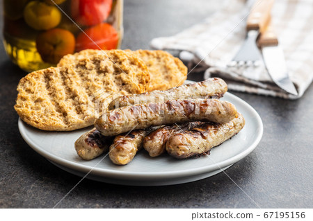 Grilled white sausages. 67195156