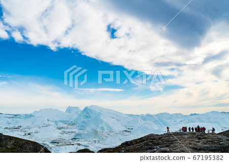 Icebergs in arctic landscape nature with travel tourists in Greenland 67195382
