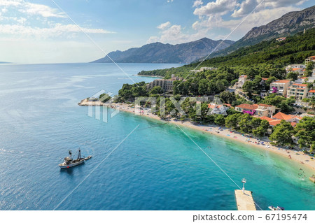 Aerial view of Brela with beach and fishing boat in Dalmatia, Croatia 67195474
