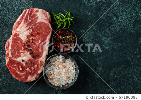 Raw fresh meat Ribeye Steak and seasoning. Raw fresh meat Ribeye Steak and seasoning. 67196085