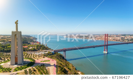 Aerial bridge on April 25th, Lisbon, Portugal. Statue of jesus christ lisbon. Sunny day. Close-up. Aerial bridge on April 25th, Lisbon, Portugal. Statue of jesus christ lisbon. Sunny day. Close-up. 67196427