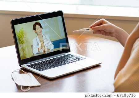 Woman receiving online medical treatment Woman receiving online medical treatment 67196736