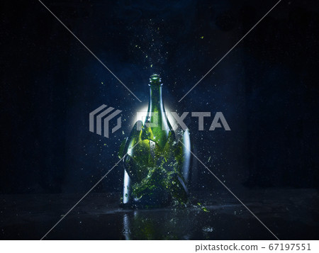 The moment the bottle with drink breaks into pieces 67197551