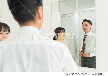 Middle-aged couple preparing for work 67198050