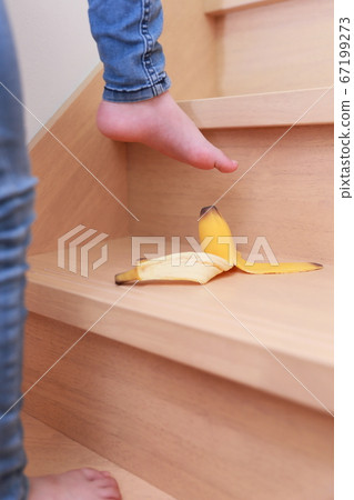 Girl likely to slip on banana skin when climbing up and down the stairs Girl likely to slip on banana skin when climbing up and down the stairs 67199273