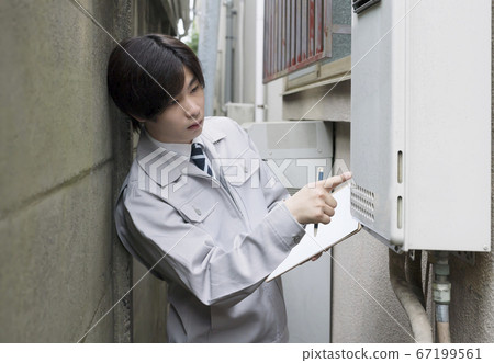 Businessman inspecting a house water heater Businessman inspecting a house water heater 67199561