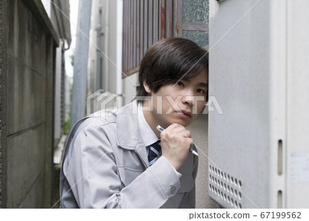 Businessman inspecting a house water heater 67199562