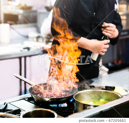 Chef cooking, Chef preparing food in the kitchen Chef cooking, Chef preparing food in the kitchen 67205681