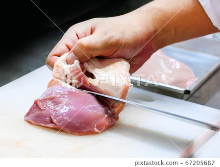 chef cutting Chicken fillet breast on board, chef 67205687