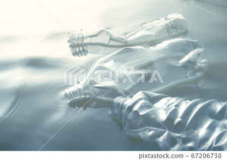 Plastic bottle floating on the water 67206738