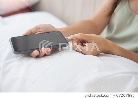 Woman hands charging battery in mobile smart phone 67207685