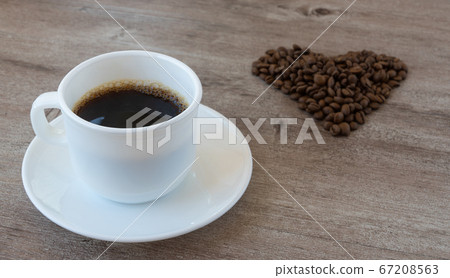 making coffee. Cup of fragrant coffee. beans are laid out in the shape of a heart. 67208563