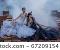 Pretty Asian Thai women holding beautiful garland in here hand and wearing traditional Thai dress costume according culture with the old brick wall at the ancient temple Chiangmai Thailand. 67209154