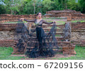 Woman wearing typical thai dress with thai style, Beauty fantasy Thai dress traditional costume on brick in old temple 67209156