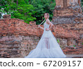 Woman wearing typical thai dress with thai style, Beauty fantasy Thai dress traditional costume on brick in old temple 67209157