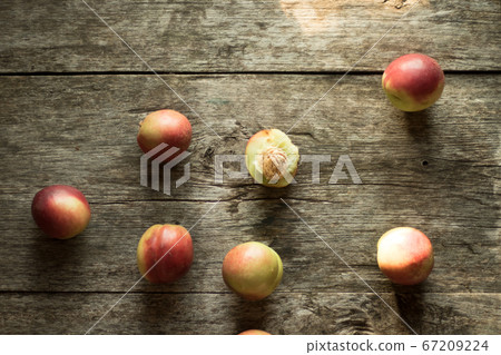 Nectarines lie on a wooden table. Conservation for the winter. Rustic design, minimalism. Nectarines lie on a wooden table. Conservation for the winter. Rustic design, minimalism. 67209224