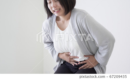 Woman with stomachache Woman with stomachache 67209435