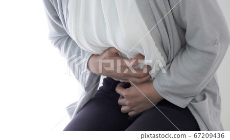 Woman with stomachache Woman with stomachache 67209436