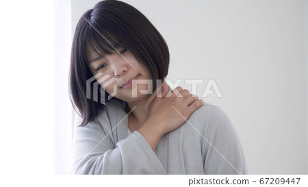 A woman with stiff shoulders A woman with stiff shoulders 67209447