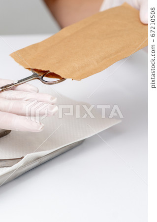 Manicurist hands taking manicure tools Manicurist hands taking manicure tools 67210508