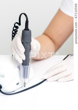 Electric manicure machine in manicure master hand 67210509