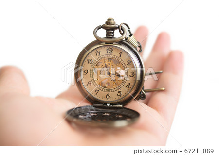 Men hands hold a pocket watch and a white background. 67211089