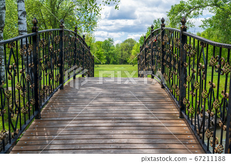 wooden bridge with metal railings 67211188