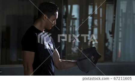 Men training in the gym 67211605