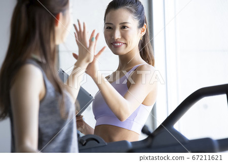 Female trainer working in the gym Female trainer working in the gym 67211621