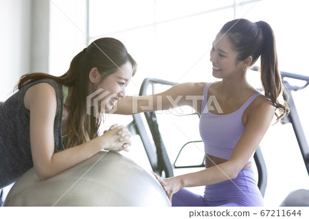 Women exercising at the gym 67211644