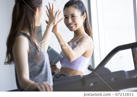 Female trainer working in the gym 67211651