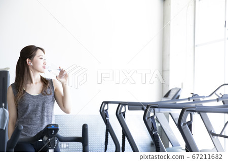 A woman taking a rest at the gym A woman taking a rest at the gym 67211682
