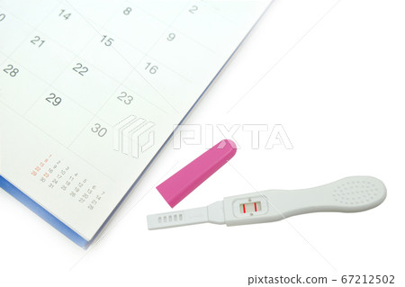 Positive white plastic pregnancy test with calendar isolated on white background. Positive white plastic pregnancy test with calendar isolated on white background. 67212502