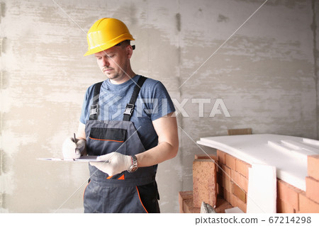 Engineer in work clothes and safety helmet 67214298