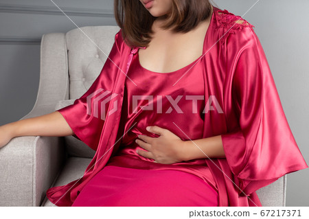 Menstrual cramps and causes tummy ache of woman 67217371