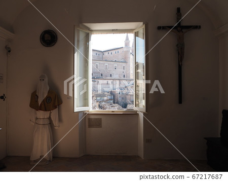 Medieval European cityscape seen between a creepy soldier and a crucifix 67217687
