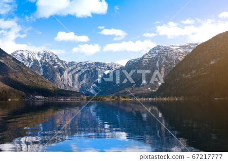 View idyllic Alpine mountains and lake Hallstattersee. Sunny winter morning in Austria View idyllic Alpine mountains and lake Hallstattersee. Sunny winter morning in Austria 67217777