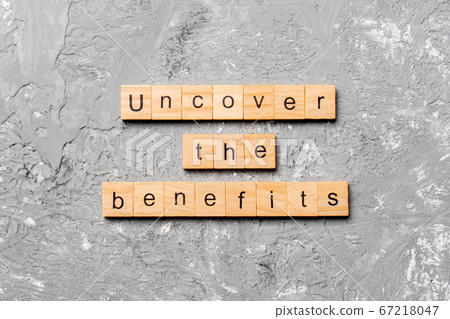 uncover the benefits word written on wood block. 67218047