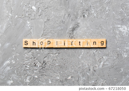 Shoplifting word written on wood block. 67218050