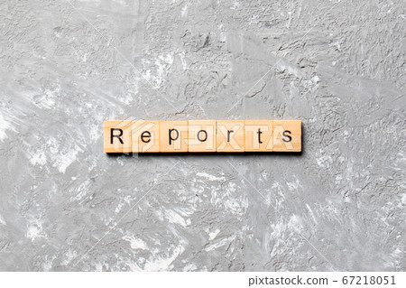 REPORTS word written on wood block. REPORTS text 67218051