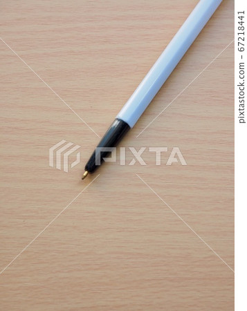 Wooden board background and black ballpoint pen 67218441