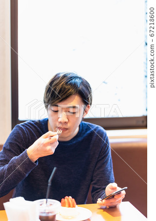 年輕人在咖啡館吃蛋糕 年輕人在咖啡館吃蛋糕 67218600