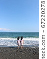 Twin girls staring at the sea Twin girls staring at the sea 67220278