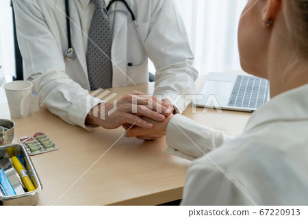 Doctor in professional uniform examining patient at hospital 67220913