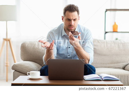 Adult handsome man using voice assistant on smartphone 67221367