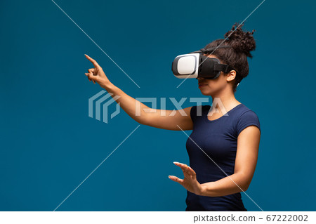 Young black girl wearing VR headset, innovative technologies 67222002