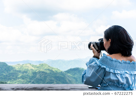 Tourists taking photo of natural scenery Tourists taking photo of natural scenery 67222275