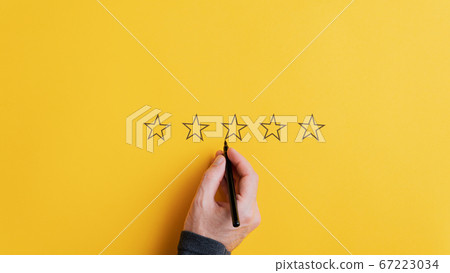 Male hand drawing five stars in a row Male hand drawing five stars in a row 67223034