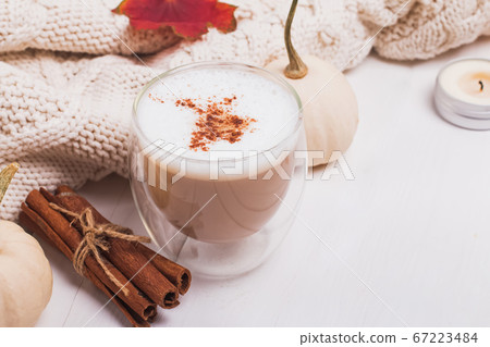 Cup of coffee with milk and cinnamon, autumn leaves and pumpkins Cup of coffee with milk and cinnamon, autumn leaves and pumpkins 67223484